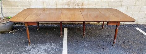 Mid 19th century mahogany extending fall-flap dining table with concertina action and with three