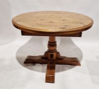Pine circular pedestal dining table on quadruple supports, 109cm wide and four pine ladderback