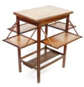 Edwardian oak metamorphic side table with revolving and unfolding top and four pull-down shelves,