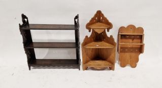 Late Victorian/Edwardian dark stained oak fret carved hanging wall shelves, a hanging corner display