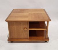 20th century blonde oak coffee table of rectangular form with various storage compartments raised on