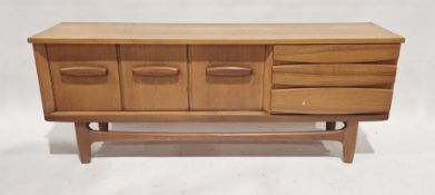 Mid century teak sideboard in the manner of Jentique, with central fall front door flanked by double