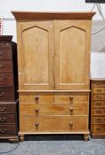 Victorian pine linen press, the upper section enclosed by two arched panel doors over chest base