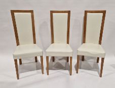 Set of 8 modern lightwood-framed high pad backed upholstered dining chairs