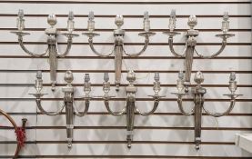 Set of six silver-plated two-branch wall sconces, each with acorn finial and pair fluted C-scroll