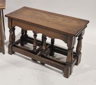 Nest of three oak tables with baluster supports
