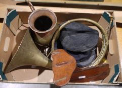Brass horn, a brass and copper jug, two black peaked caps, a vintage brass-bound mahogany wooden