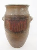 Large 20th century two-handled brown stoneware jar, with ribbed bands and two loop handles, 57.5cm