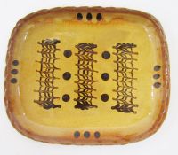 Coldstone Pottery slipware dish, of shaped rectangular form, decorated in brown slip with combed and