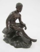 Figure of Hermes seated on a rock, Caduceus staff missing, 20cm long x 20cm high.