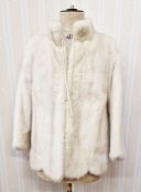 A cream mink jacket with scalloped hem, mandarin collar, (three quarter length bracelet sleeves,)