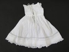 An Edwardian child's lawn cotton nightdress/petticoat, pintuck and frill detail, long sleeves with