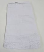White cotton apron with a lace and whitework bib, two Victorian nightgowns both pintucked broderie