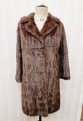 A vintage squirrel coat with embroidered satin lining, a short vintage fur cape labelled 