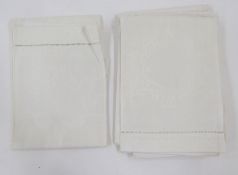 Four damask hand towels and another, two sets of 12 various table mats with crocheted borders and