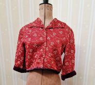 A selection of vintage jackets, a red quilted short jacket with velvet cuffs and velvet trim
