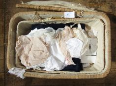 Various baby clothes, adult lingerie, blankets, lace pieces, assorted items all within a nursery