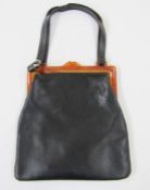 Mid 20th century leather handbag with amber-coloured bakelite fixed frame and leather handle, an
