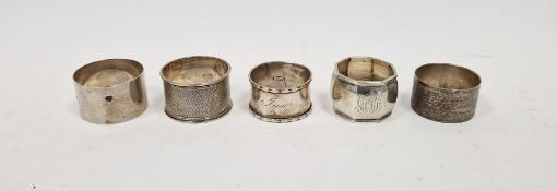 Five assorted silver napkin rings, two having engine turned decoration, gross weight approximately