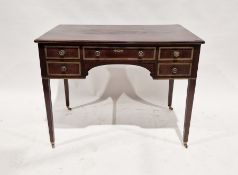Early 20th century mahogany kneehole desk, the drawers having brass-bound borders with brass