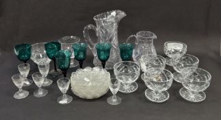 Six green tinted bell-shaped wine glasses, six engraved liqueur glasses etched with thistle and a