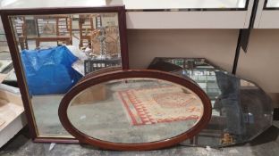 Early 20th century mahogany-framed bevel edged wall mirror of oval form with inlaid decoration to