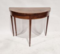 Victorian mahogany folding card table of demi-lune form, opening to reveal a green baize top, raised