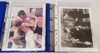 Two folders of official publicity film stills to include Westerns, Disney, Laurel & Hardy, Charlie