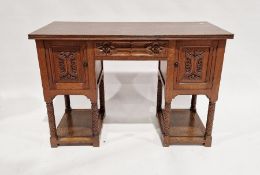 20th century carved oak desk having a central long drawer flanked on either side by a single door