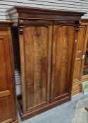 Victorian flame mahogany wardrobe and linenpress with scroll bracket supports above moulded cornice,