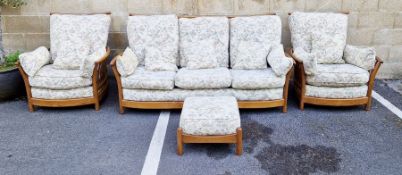 20th century oak three-piece sofa suite by Ercol, design no.1154, comprising a three-seater sofa and