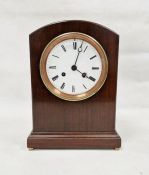 20th century arch topped mahogany cased mantel clock with brass bun feet, roman numerals, moon hands