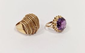 Two gold-coloured rings, one inset faceted blue-purple stone and the other of filigree hooped
