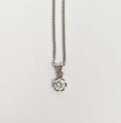 18ct gold solitaire diamond pendant on fine 18ct white gold curb-link chain, the claw-set stone 0.