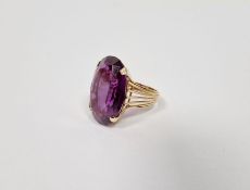 Gold-coloured metal and large amethyst-coloured stone ring set single oval faceted stone (marked