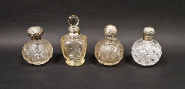 Collection of four silver mounted cut glass perfume bottles, three of globular form, the largest
