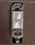 Gucci Tornabuoni 119 lady's wristwatch, the rectangular dial surrounded with small diamonds on the