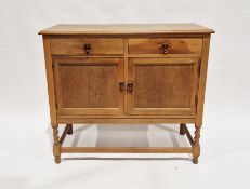 20th century oak kitchen dresser base having two short drawers over two single door cupboards, on