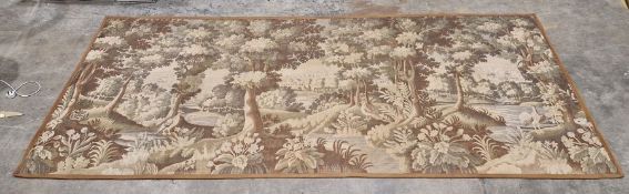 Modern machine-made tapestry wall hanging depicting a romantic woodland scene in hues of greens,