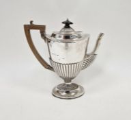 Victorian silver coffee pot, with half gardrooned decoration, raised on a pedestal base, with wooden
