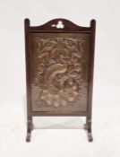 Early 20th century Art Nouveau hammered copper firescreen depicting a peacock perched on a vine,