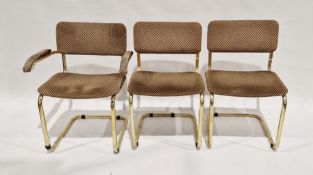 Set of three 20th century gilt metal tubular chairs, each with upholstered seat and back, one