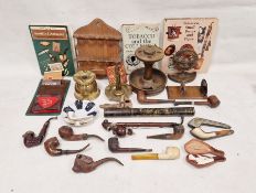 Collection of smoking paraphernalia including pipe stands, assorted pipes including meerschaum