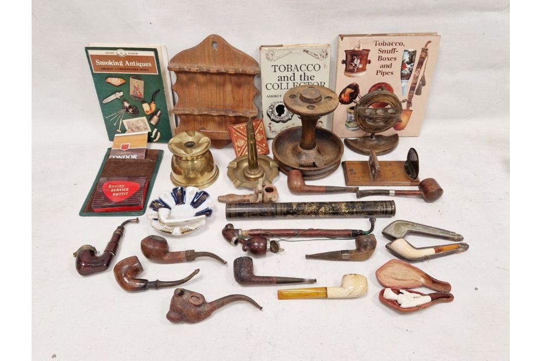 Collection of smoking paraphernalia including pipe stands, assorted pipes including meerschaum