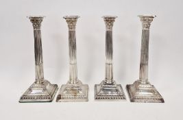 Victorian set of four large silver candlesticks, of Corinthian column form, on square bases,