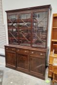 Victorian mahogany library bookcase, the top section having three glazed doors, raised over three