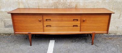 Mid century teak sideboard by Younger, the three graduating central drawers flanked by cupboards,