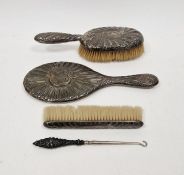 Matched four piece set of silver mounted dressing table wares, including two brushes, a hand