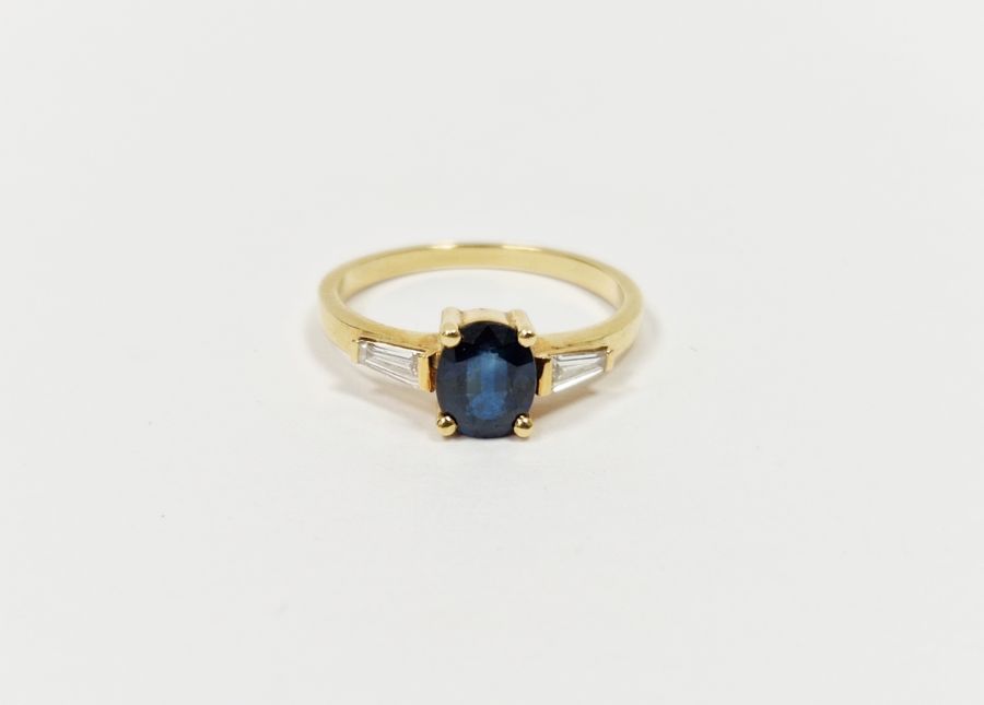 18ct yellow gold, sapphire and diamond ring set oval sapphire flanked by two tapering baguette- - Image 2 of 2