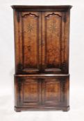 Georgian-style oak two-tier corner cupboard, the two-door top section opening to reveal two fitted